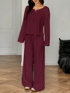 Burgundy casual two-piece lounge set featuring a long sleeve top and wide leg pants detail.