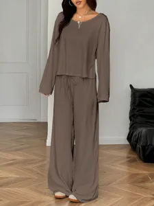 Detail view of casual long sleeve top and wide leg pants set in brown color for women.