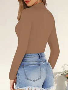 Detail view of women solid brown mock neck long sleeve slim fit bodysuit paired with denim shorts.