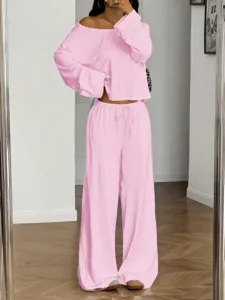Detail view of the stylish pink off-shoulder long sleeve top and wide leg pants set worn.