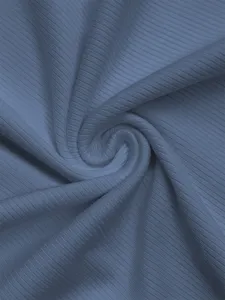 Gros plan sur les details du tissu côtelé bleu poussiéreux, texture douce et maille extensible.