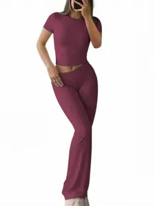 Casual solid color slim short sleeve top and flared pants set for women, stylish outfit.
