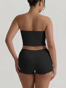 Back view detail of the solid black strapless crop top and matching shorts set, slim fit style.