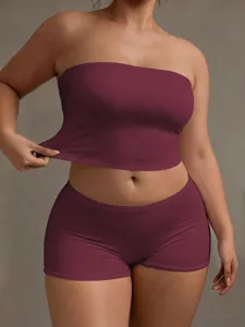 Detail shot of the burgundy bandeau top and shorts set, showcasing elastic fabric and slim fit.
