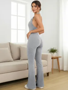Close-up detail of the grey halter open-back tight jumpsuit in a stylish living room setting.