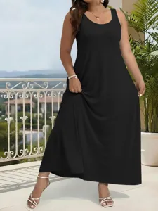 Detail view of a solid black sleeveless plus size maxi dress worn by a model on a sunny terrace.