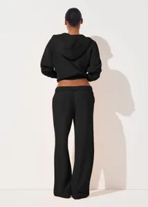 Detailed back view of women's black zip-up hoodie and wide-leg pants set for casual wear.