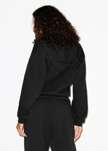 Back detail view of the casual black hoodie and sweatpants set, featuring relaxed fit comfort.