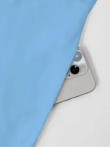 Close-up view of the light blue smooth dress fabric texture showing fine details.