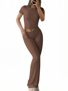 Women solid color slim short sleeve top and flare pants two piece set casual outfit detail.