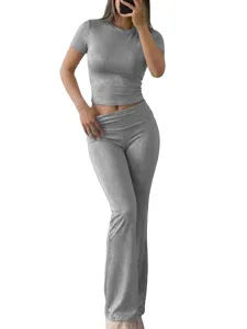 Grey short sleeve crop top and flared pants set detail view showing soft shimmering fabric.