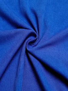 Blue ribbed fabric close-up, soft knit texture detail shot, premium apparel material.