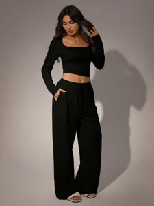 Black long sleeve crop top and loose trousers set, square neck casual lounge wear outfit.