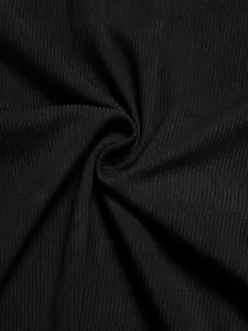 Black ribbed knit fabric detail close up showing texture and elasticity for apparel.