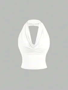 Close-up detail of white cowl neck halter top, sleeveless design, soft fabric texture.