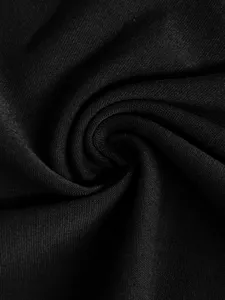 Close up detail shot of premium black fabric material showcasing smooth texture and fine weave.