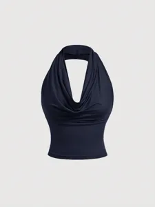 Close-up detail of the dark blue cowl neck halter top, showcasing the elegant draped neckline.