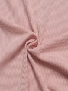 Pink ribbed fabric detail shot showcasing soft texture and elastic material quality.