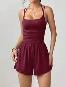 Burgundy halter jumpsuit detail showing gathered waist design and loose shorts fabric texture.