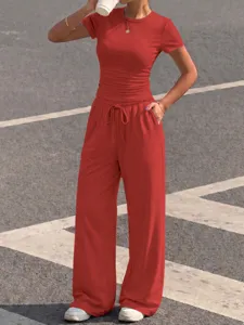 Detail view of women's red short sleeve top and wide leg drawstring pants casual set.