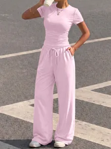 Pink casual two-piece set featuring a ribbed short-sleeve top and matching drawstring pants.