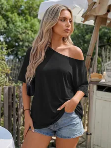 Casual loose off-shoulder black t-shirt detail showing relaxed fit and short sleeves.