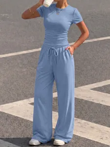 Casual blue two-piece lounge set featuring a fitted short sleeve top and wide leg pants.