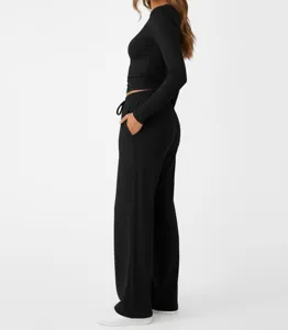 Detail view of women's black long sleeve crop top and matching casual lounge pants set.