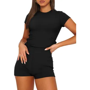 Close-up detail of solid black short-sleeve top and matching shorts set, casual comfortable wear.