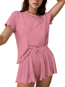 Pink ribbed knit short sleeve top and shorts set detail, soft fabric texture close-up view.