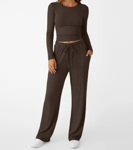 Stylish solid color long sleeve crop top and casual lounge pants activewear set for women.
