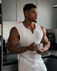 Detail view of men's summer knitted ribbed white slim fit tank top in kitchen scene.