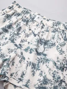 Women casual lounge shorts detail view, green landscape print, high waist with elastic and buttons.