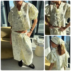 Women floral print gauze lounge set with ruffle puff sleeve crop top and wide leg pants.