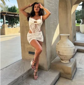 Sexy sheer white lace two-piece outfit featuring a stylish corset top and matching mini skirt.