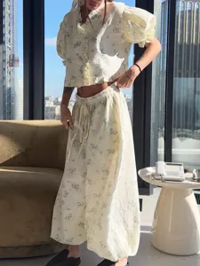 Casual floral two-piece set featuring a ruffle collar puff sleeve crop top and wide leg pants.