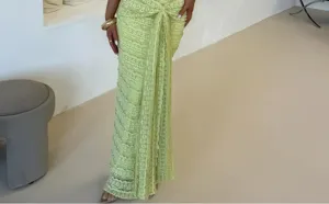 Detailed close-up view of a stylish light green textured maxi skirt with front knot accent.