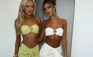 Detailed view of women's fashionable two-piece set crop tube top and skirt with shell decor.