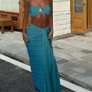 Close-up of the stylish blue knit strapless top and wrap skirt two-piece set outdoors.