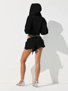 Detailed view of the black cropped hoodie and shorts set, showing the back design and fit.