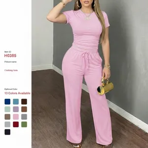 Women's two-piece pink short sleeve top and casual sweatpants lounge set Y2K fashion.