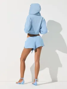 Light blue cropped hoodie and matching shorts set, casual sporty two-piece outfit for women.
