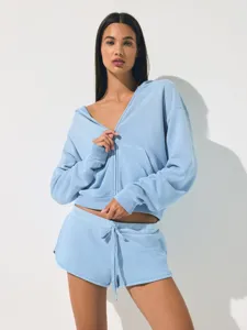 Light blue zip-up hoodie and shorts set, casual athletic crop top and drawstring shorts detail.