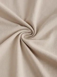 Close up view of soft knitted fabric detail showcasing fine texture and elegant neutral color tone.