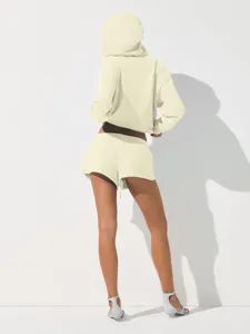 Back view details of light yellow cropped hoodie and matching shorts casual athletic set.