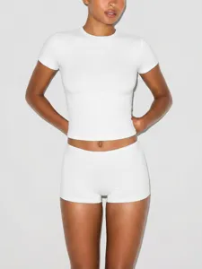 Close-up detail of the stretch fitted short sleeve top and matching shorts in crisp white.