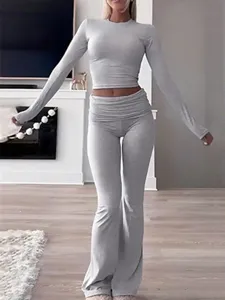 Grey two-piece lounge set featuring a long sleeve crop top and flare pants for women.