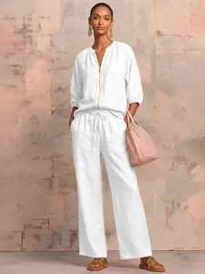 Detailed view of women's casual white two-piece set, zipper top and loose wide-leg pants.