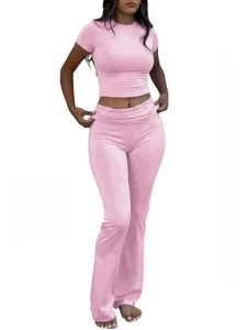 Close-up detail of the stylish pink cropped t-shirt and low-waist flared pants set.