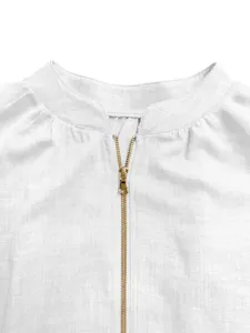 White blouse neckline detail showcasing a sleek golden zipper and elegant round collar design.